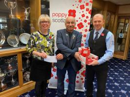 Prestwick Rotarian Adnan Soojeri received £241.00 and a Poppy box full of money from St Nicholas Golf Club.